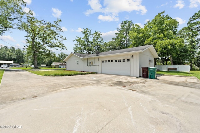 view of side of home with a yard and a garage