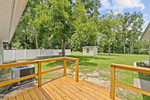 wooden deck with cooling unit, a shed, and a yard