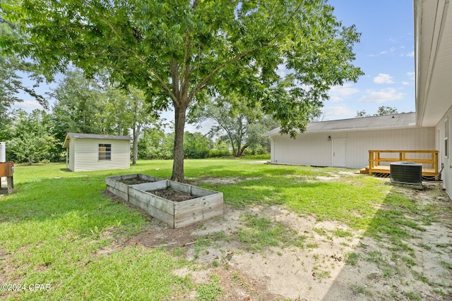 view of yard with a storage shed and central air condition unit