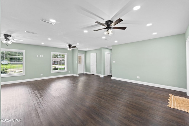 unfurnished living room with dark hardwood / wood-style floors and ceiling fan