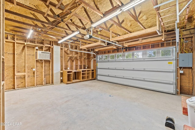 garage with an AC wall unit and a garage door opener