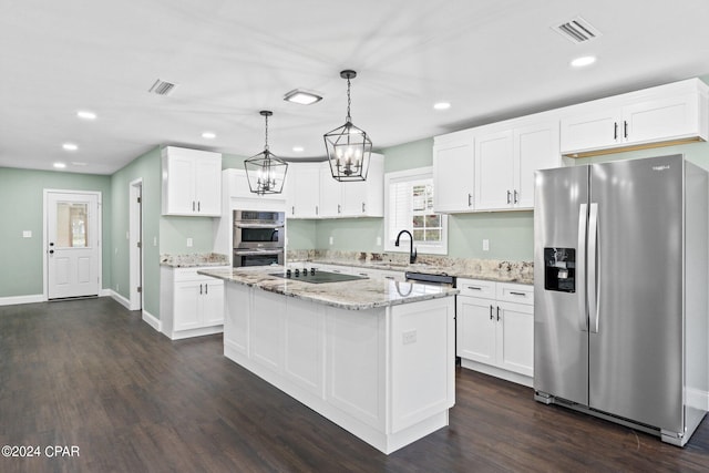 kitchen with dark wood-type flooring, hanging light fixtures, a kitchen island, white cabinets, and appliances with stainless steel finishes