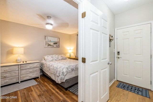 bedroom with ceiling fan and dark wood finished floors