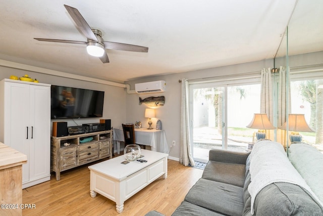 living area featuring a wealth of natural light, an AC wall unit, ceiling fan, and light wood finished floors