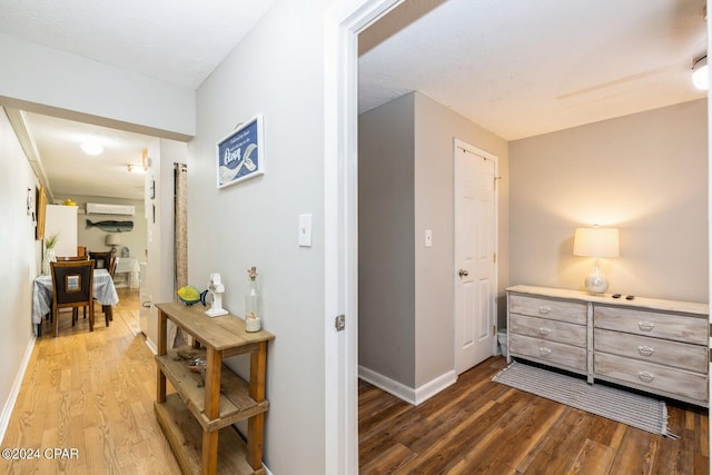 hallway with wood finished floors and baseboards