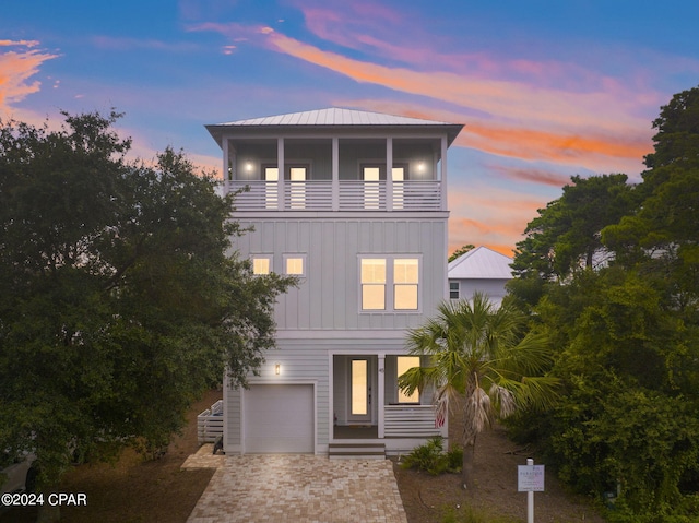 view of front facade featuring a balcony and a garage