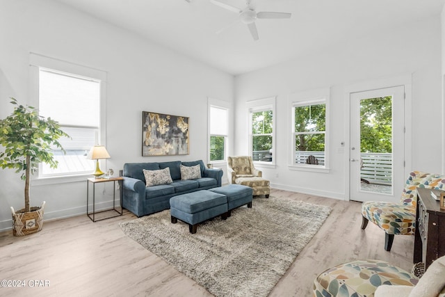 living room featuring ceiling fan and light hardwood / wood-style floors