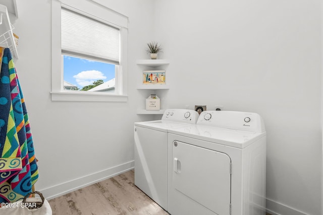 laundry room featuring washer and clothes dryer and light wood-type flooring