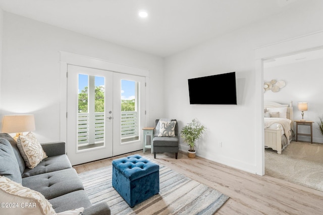 living room with light hardwood / wood-style floors and french doors