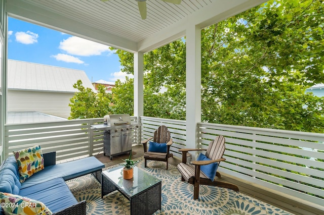 wooden terrace with an outdoor living space and ceiling fan