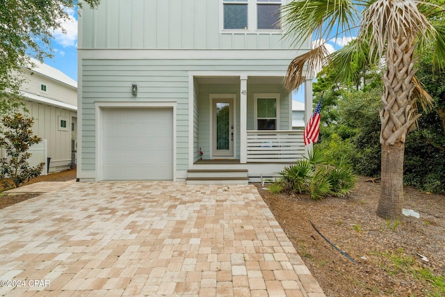 view of front of home with covered porch and a garage