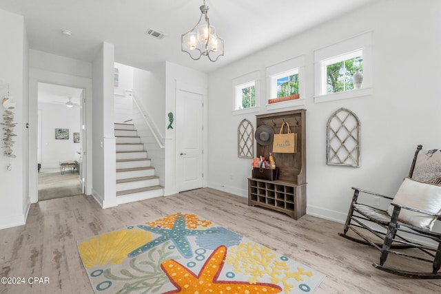 interior space featuring light hardwood / wood-style flooring and a notable chandelier