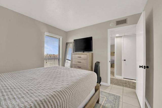 bedroom with light tile patterned floors