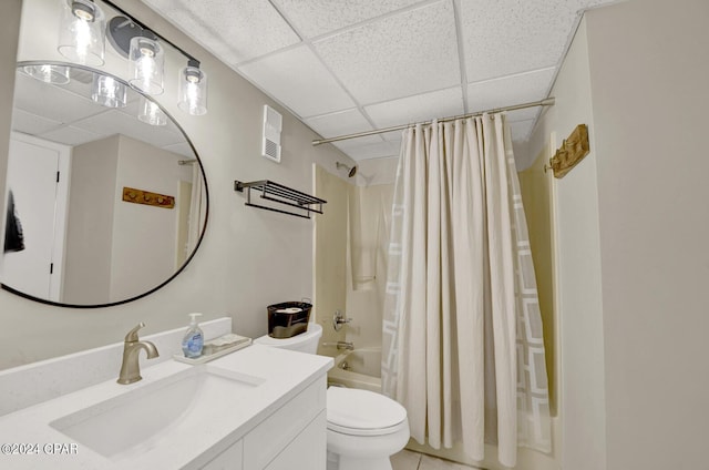 full bathroom featuring shower / bath combo, a paneled ceiling, vanity, and toilet