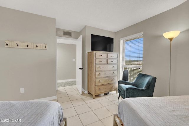 tiled bedroom featuring a textured ceiling