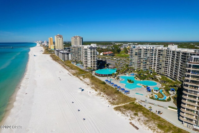 drone / aerial view with a water view and a beach view