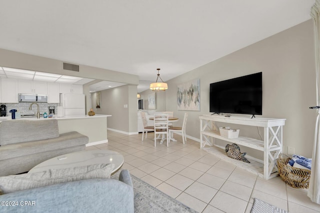 living room with sink and light tile patterned flooring