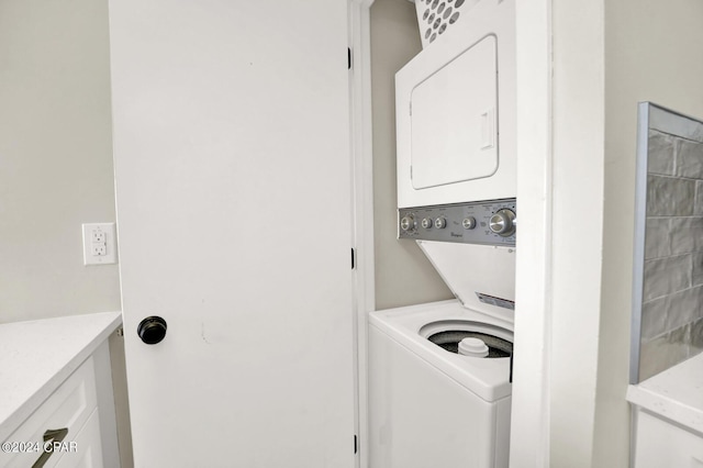 laundry area with stacked washing maching and dryer