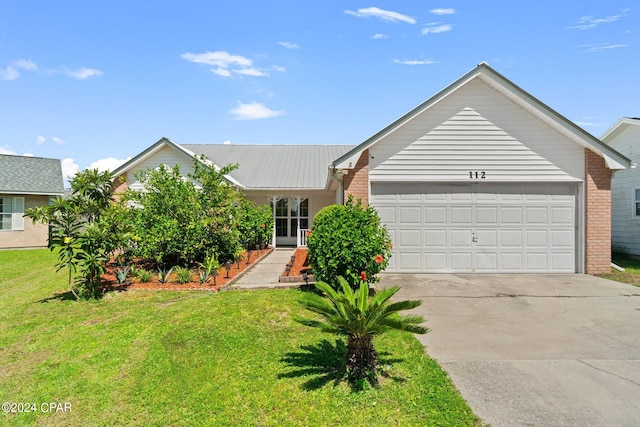 single story home with a garage and a front lawn