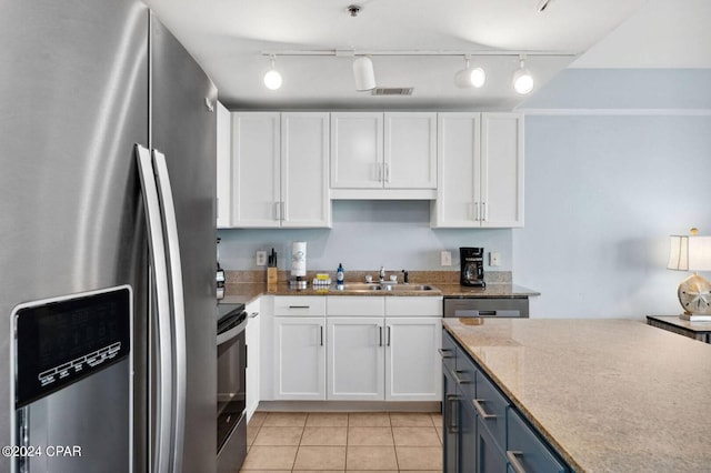 kitchen with blue cabinets, stainless steel refrigerator with ice dispenser, sink, and white cabinetry