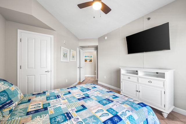 tiled bedroom featuring ceiling fan