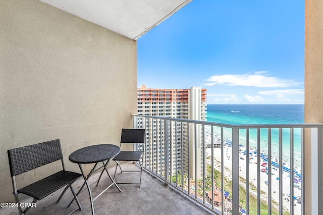 balcony with a water view and a beach view