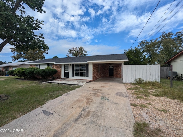 ranch-style home with a carport and a front lawn