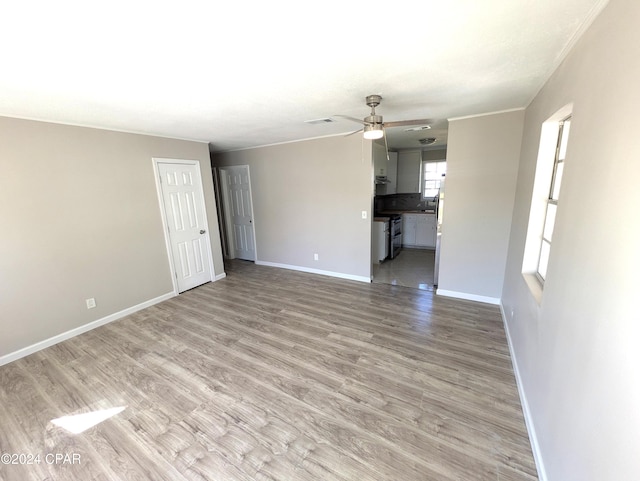 unfurnished living room featuring light hardwood / wood-style flooring and ceiling fan