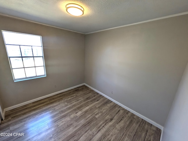 unfurnished room featuring hardwood / wood-style floors, a textured ceiling, and ornamental molding