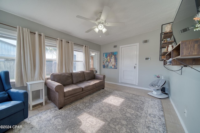 living area with light tile patterned floors, ceiling fan, and visible vents