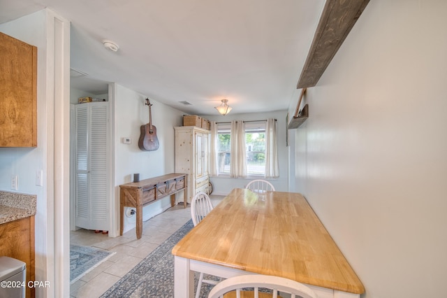 dining space with stone tile floors