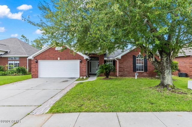 ranch-style home featuring brick siding, an attached garage, concrete driveway, and a front yard