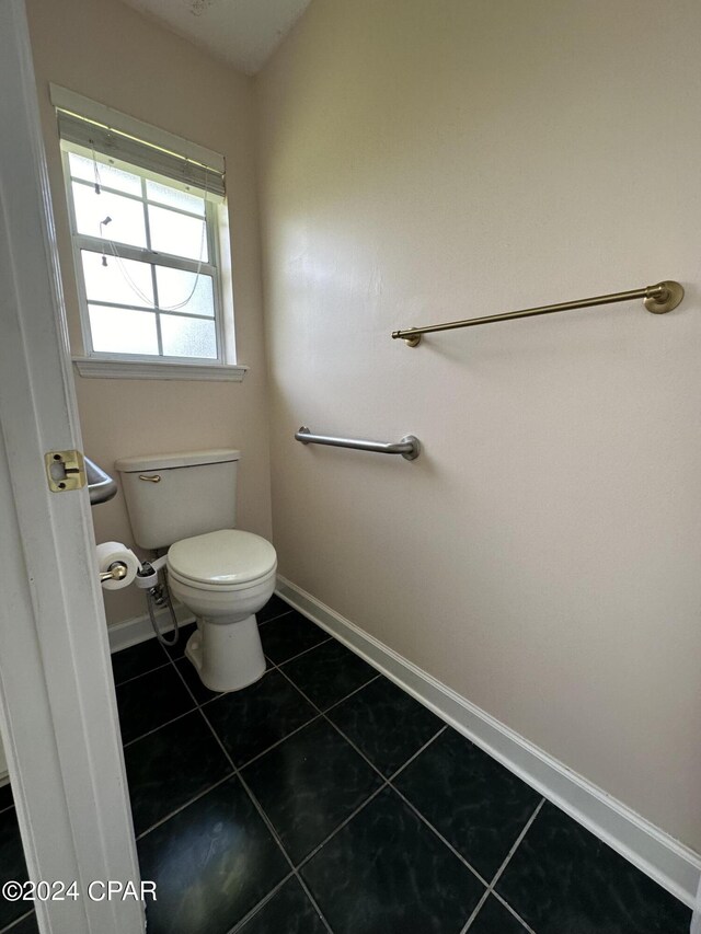 bathroom featuring toilet and tile patterned floors