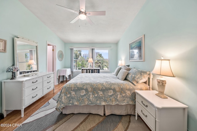 bedroom with wood-type flooring, lofted ceiling, and ceiling fan