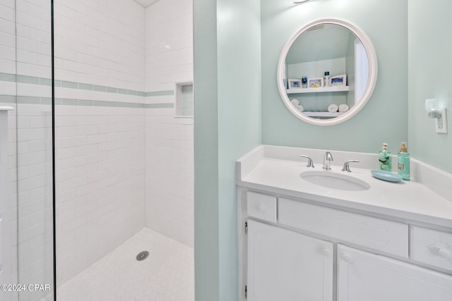 bathroom featuring vanity and tiled shower