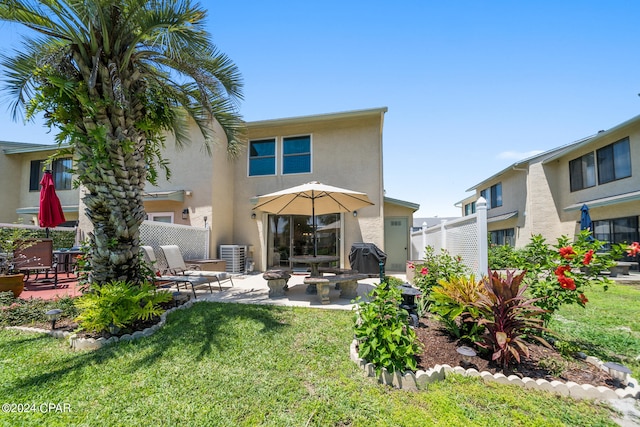 back of house with a patio, a yard, and central air condition unit