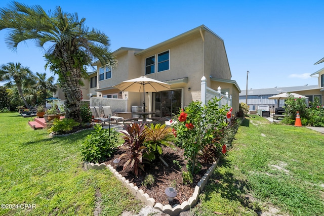 back of property featuring a patio and a yard