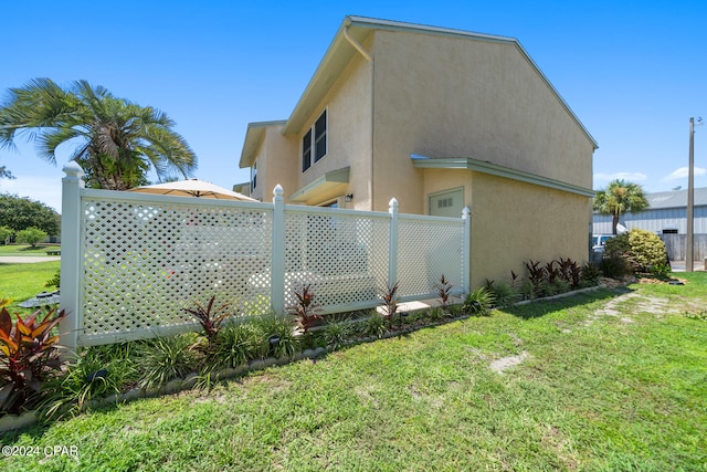 view of property exterior featuring a lawn