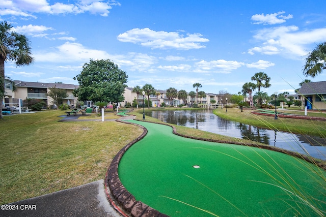 view of community with a water view and a yard