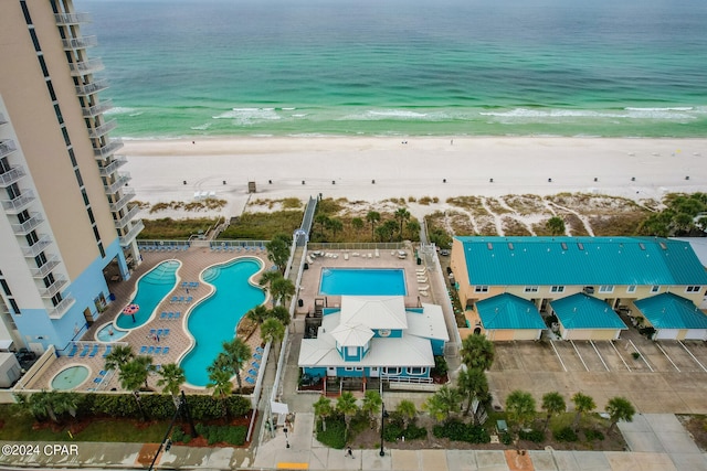 aerial view with a water view and a beach view