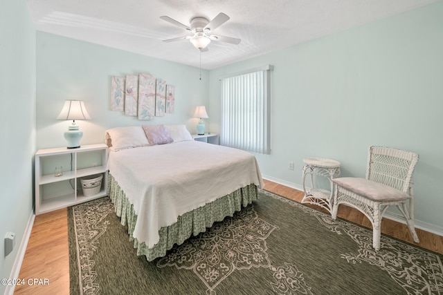 bedroom featuring ceiling fan and hardwood / wood-style flooring