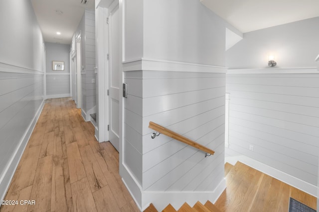 93 Emerald Cove Ln, Inlet Beach, FL 32461 - hallway featuring light wood-style floors, wood walls, and baseboards