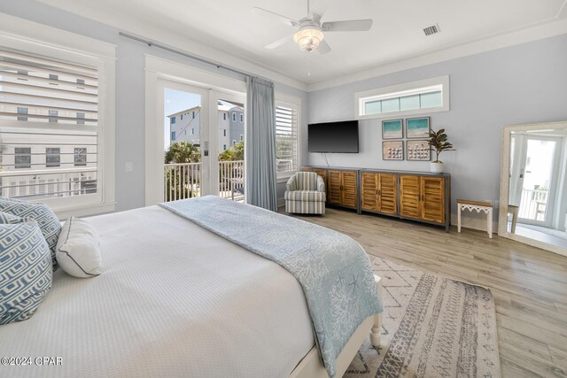 bedroom featuring ceiling fan, light hardwood / wood-style floors, crown molding, and access to exterior