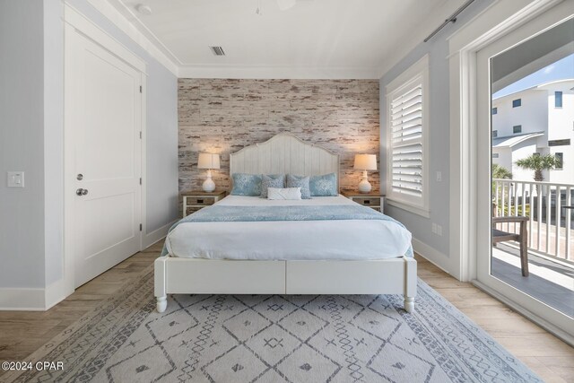 bedroom with a spacious closet, a closet, a barn door, ceiling fan, and light wood-type flooring