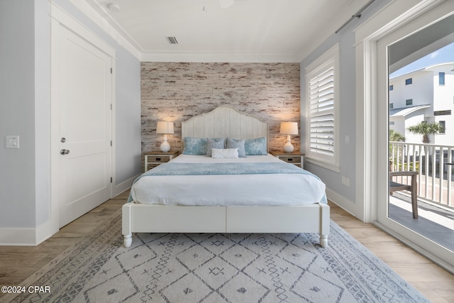 bedroom featuring light wood-type flooring, access to exterior, and ornamental molding