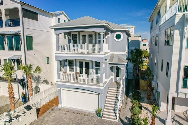 93 Emerald Cove Ln, Inlet Beach, FL 32461 - beach home featuring french doors, a garage, stairway, a balcony, and decorative driveway