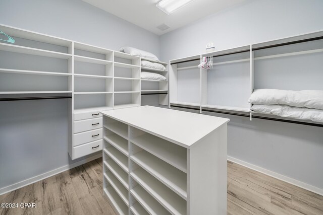 walk in closet featuring light hardwood / wood-style flooring