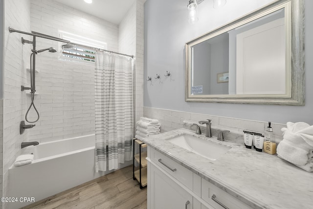 bathroom featuring vanity, hardwood / wood-style flooring, and shower / bath combo with shower curtain