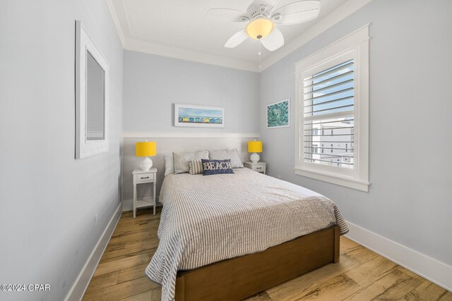 living area with ceiling fan, light hardwood / wood-style floors, and ornamental molding