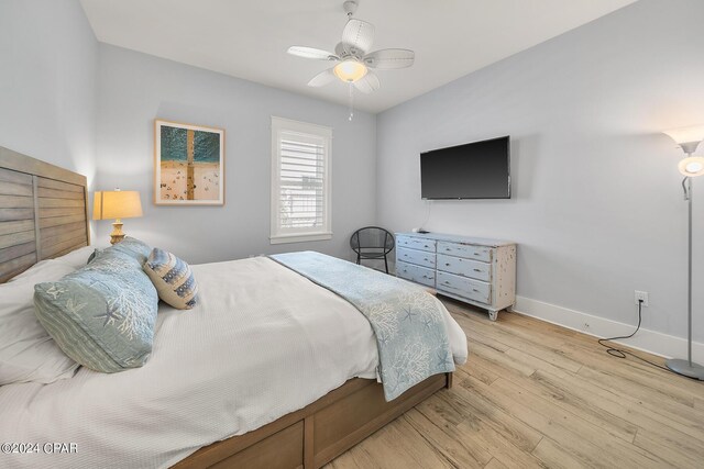 bedroom with ceiling fan and light hardwood / wood-style flooring